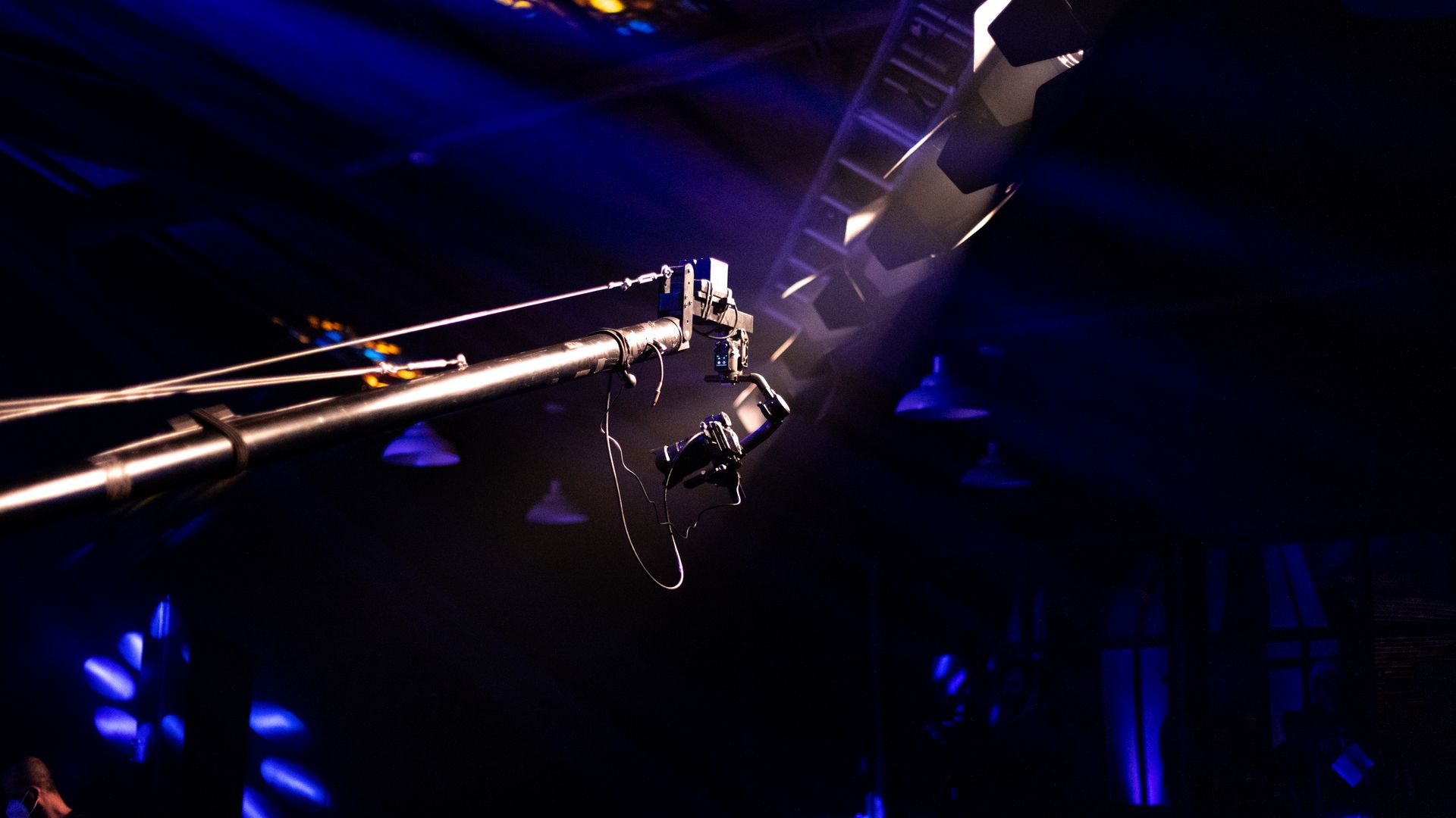 Camera crane and concert lighting expanding in the background